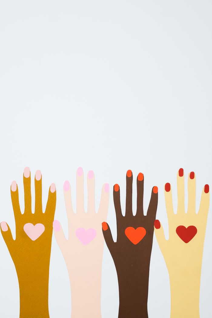 Four colorful hands with heart symbols representing diversity and inclusion.